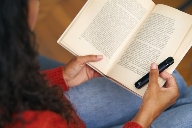 A reader holding an open paperback