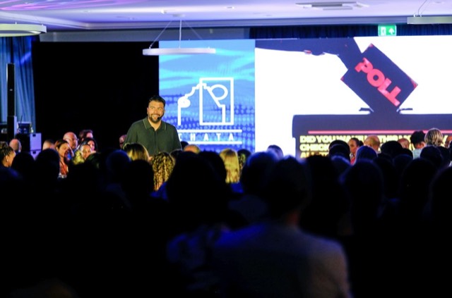 A speaker on a conference stage