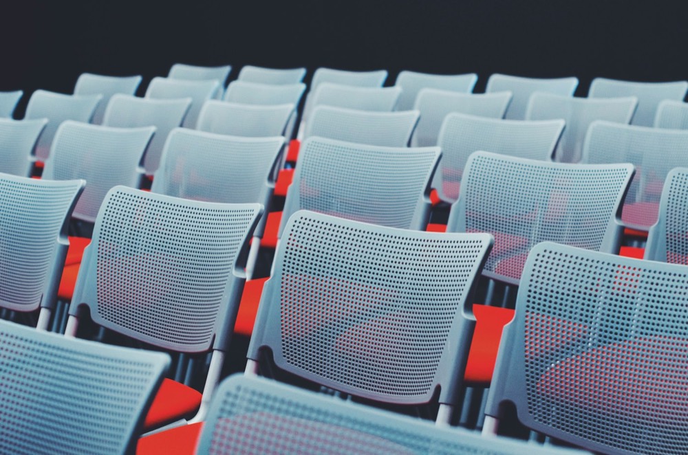 Rows of empty seats in a conference hall